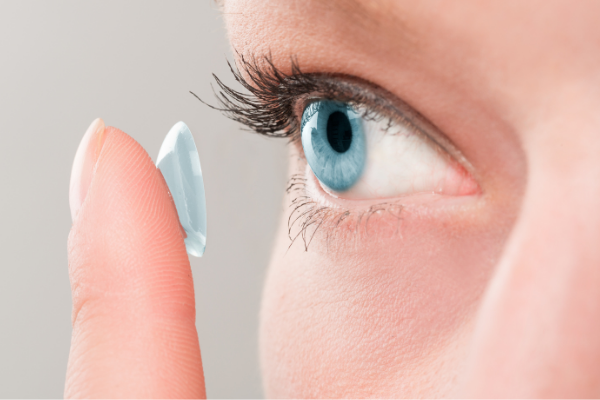 woman with contact lens on finger